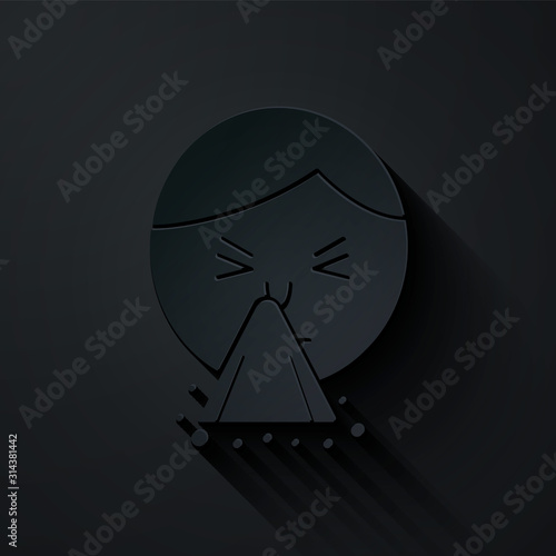 Paper cut Man holding handkerchief or napkin to his runny nose icon isolated on black background. Coryza desease symptoms. Paper art style. Vector Illustration