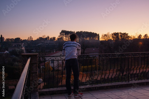 Man looking into mediterranean sunset