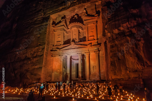 PETRA, JORDAN - MARCH 22, 2017: Tourists visit the Al Khazneh temple (The Treasury) during Petra by Night in the ancient city Petra, Jordan photo