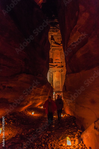 PETRA, JORDAN - MARCH 22, 2017: Candles glowing in front of the Al Khazneh temple (The Treasury) in the ancient city Petra, Jordan