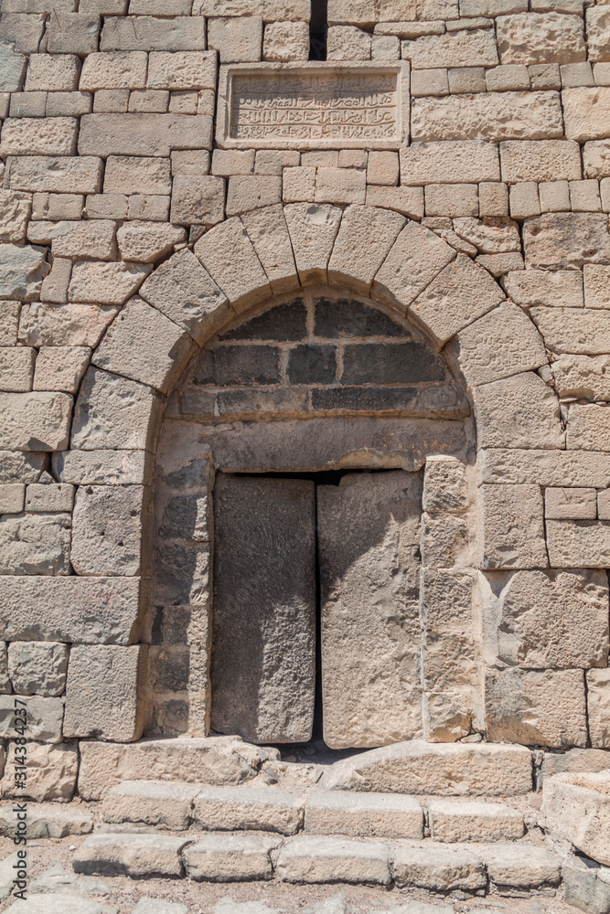 Stone door of Qasr al-Azraq (Blue Fortress), fortress located in the desert of eastern Jordan.