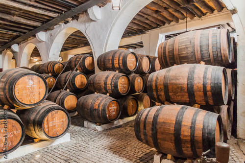 Obraz na plátne VILA NOVA DE GAIA, PORTUGAL - OCTOBER 18, 2017: Barrels of Port wine at Ramos Pinto winery cellar in Vila Nova de Gaia near Porto