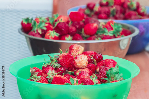 Fototapeta Naklejka Na Ścianę i Meble -  Beautiful fresh strawberries in plastic containers stands on the table
