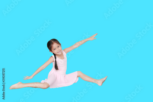 Asian little child girl dancer ballet ballerina stretching isolated on cyan background. Beautiful children in pink tutu skirt.