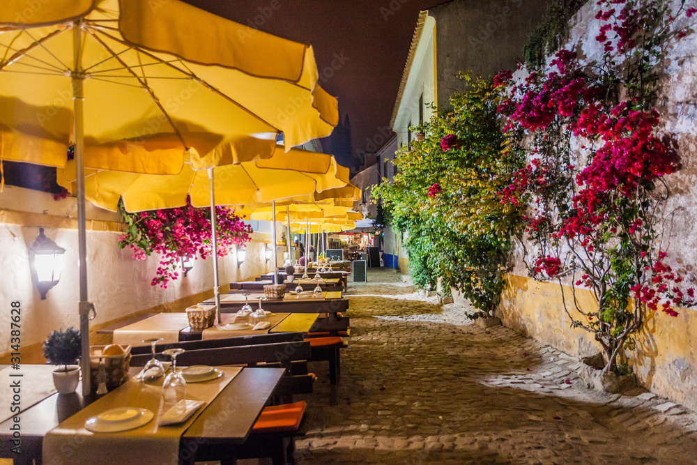 Fototapeta premium Night view of an open air restaurant in Obidos village, Portugal