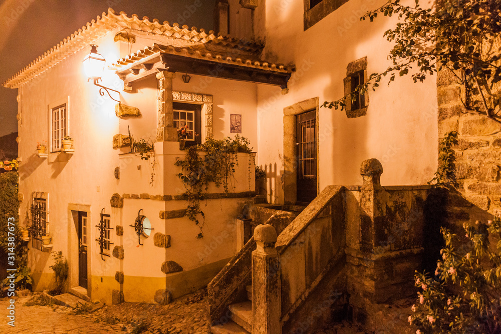 Night view of old houses in Obidos village, Portugal
