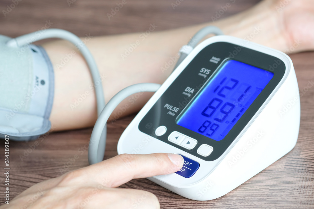 Doctor woman check blood pressure monitor and heart rate monitor pressure gauge. Health care and Medical concept Doctor woman check blood pressure monitor and heart rate monitor pressure gauge. Health care and Medical concept