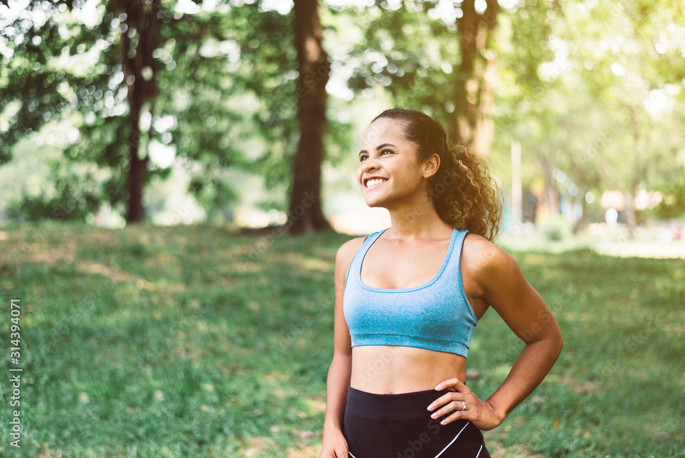 Happy black beautiful woman standing and looking to you after break workout at outdoor,Positive thinking and smiling,Relax time Happy black beautiful woman standing and looking to you after break workout at outdoor,Positive thinking and smiling,Relax time