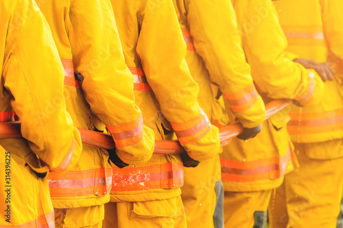 fireman fighting fire flame with water and extinguisher in training workshop, Teamwork and emergency concept photo