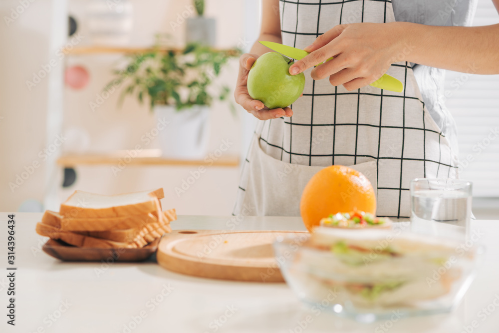 Woman preparing takeaway meal for her family Woman preparing takeaway meal for her family