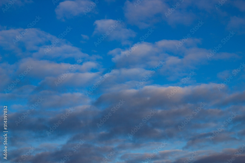 Blue sky background with white and gray clouds. Beautiful image of a huge sky and clouds