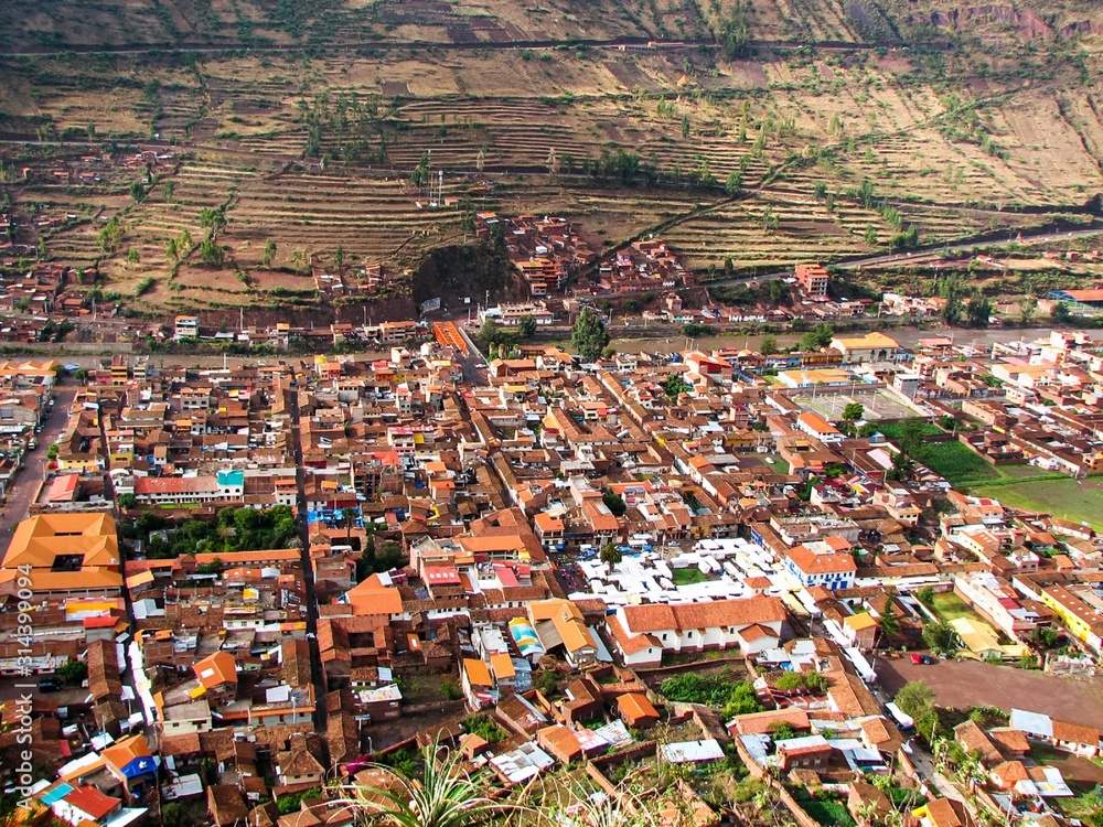 a top view of the city of Pisac, Peru, showing the orange roofs and terraces of the Incas