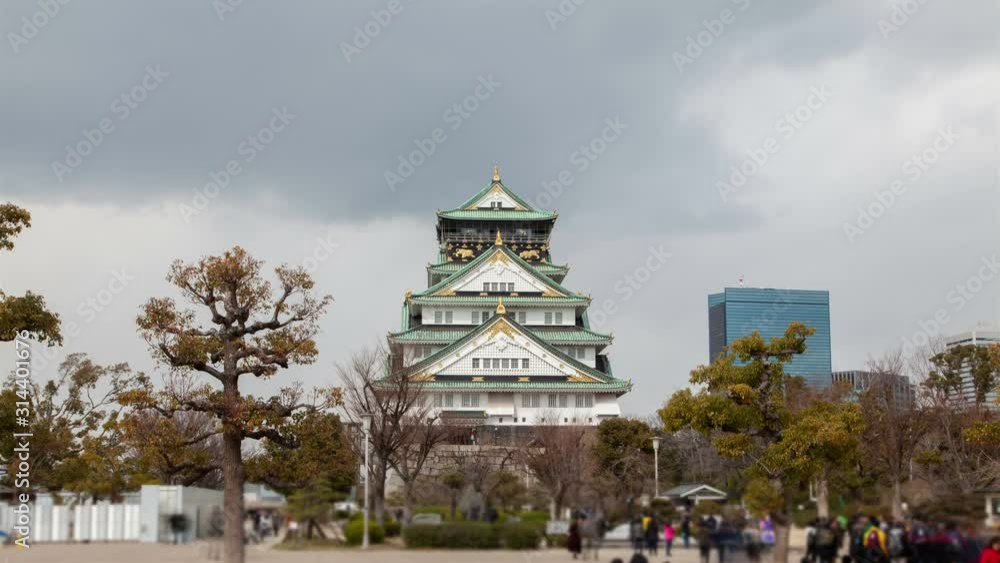 Timelapse Osaka old castle sightseers attraction with defence wall famous for museum palace in park and tourist crowd on square Timelapse Osaka old castle sightseers attraction with defence wall famous for museum palace in park and tourist crowd on square