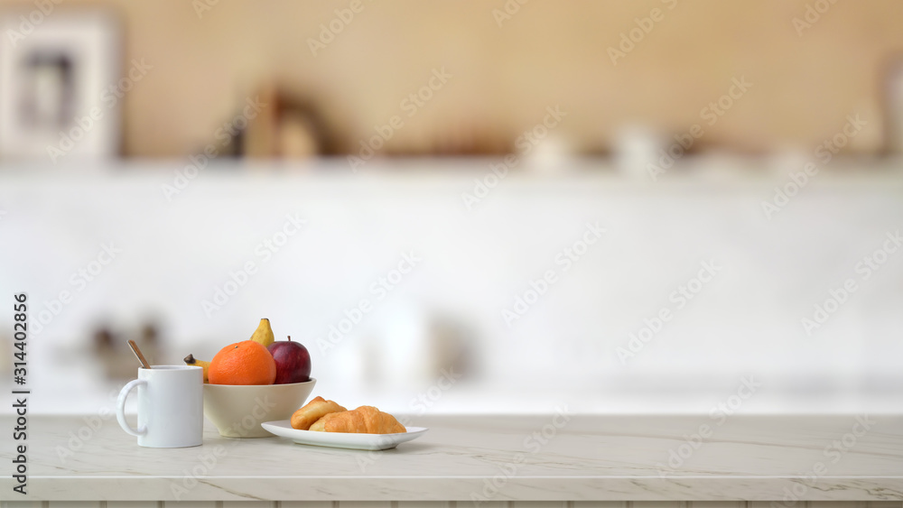 Close up view of fruit bowl, coffee cup and croissant on marble desk with blurred kitchen room - obrazy, fototapety, plakaty 