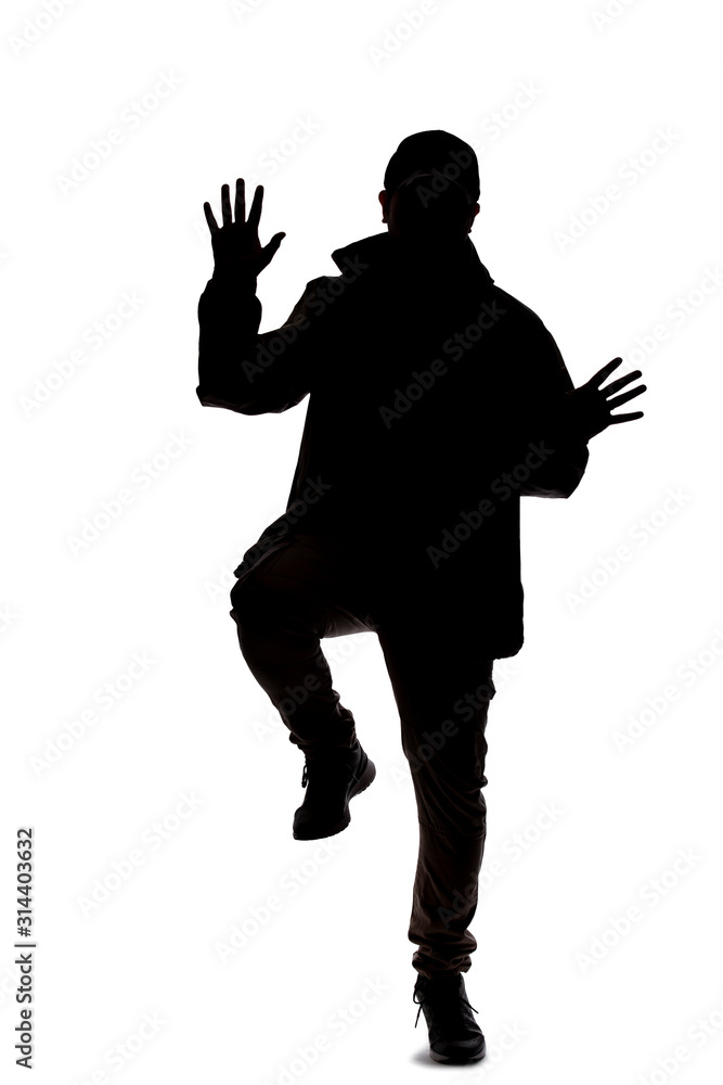Naklejka Silhouette of a male hiker or explorer isolated on a white background wearing a hat and clothes for trekking. He is gesturing as if he is happy