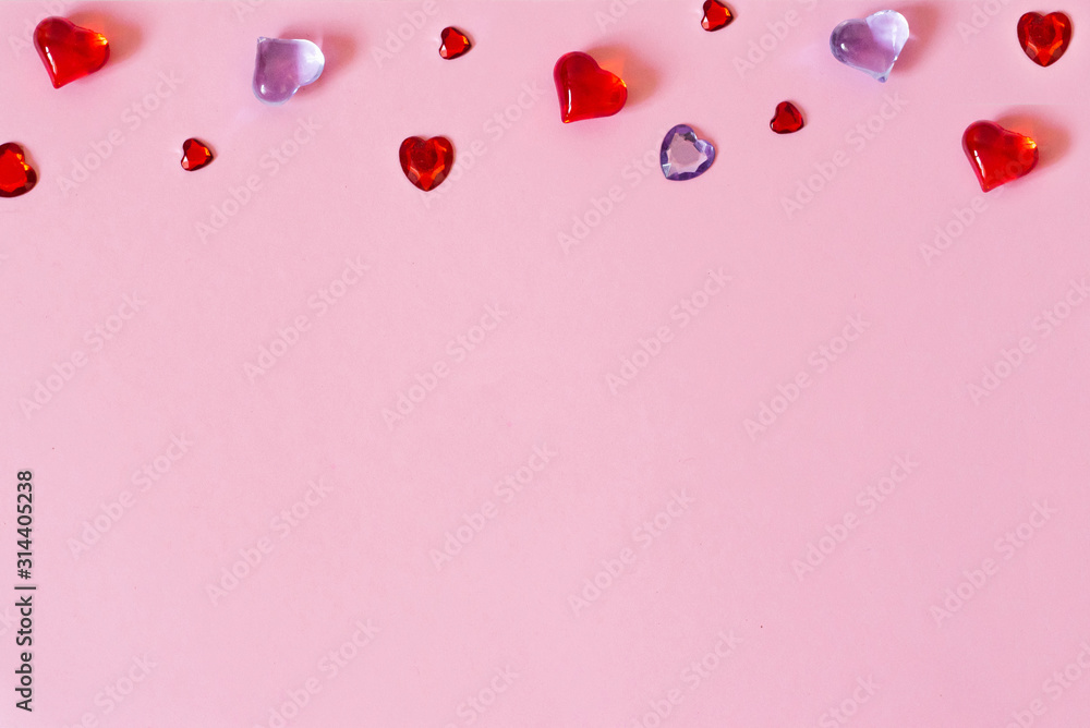 The background of Valentine's day. Border of beautiful different hearts on a pink background