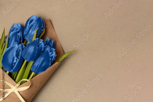Boquet of blue tulips on the cardboard background. Leftside view