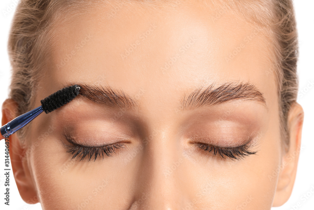 Naklejka premium Young woman undergoing eyebrow correction procedure, closeup