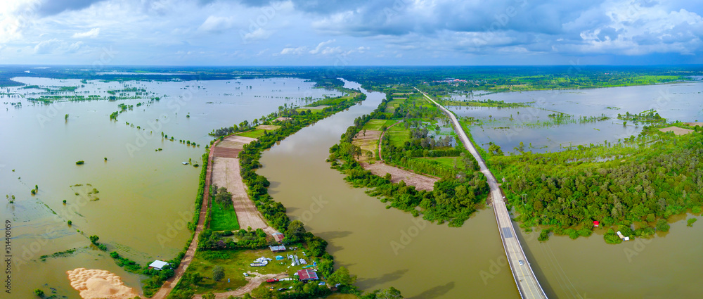 Panorama Top view Aerial photo from flying drone.Flooded rice paddies and village.Flooding the fields with water in which rice sown. View from above,Moon river,Sisaket province,Thailand,ASIA.