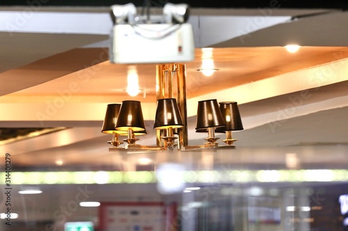 interior of restaurant A reddish-brown lamp hanging from the ceiling in the building.