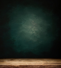 Wood table in front of rustic brick wall blur background with empty copy space on the table for product display mockup. Retro design montage presentation.