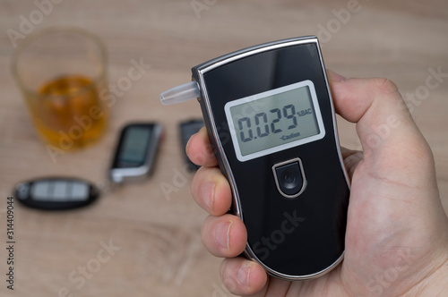 breathalyzer, alcohol and car keys, the concept of driving a car under the influence of alcohol photo