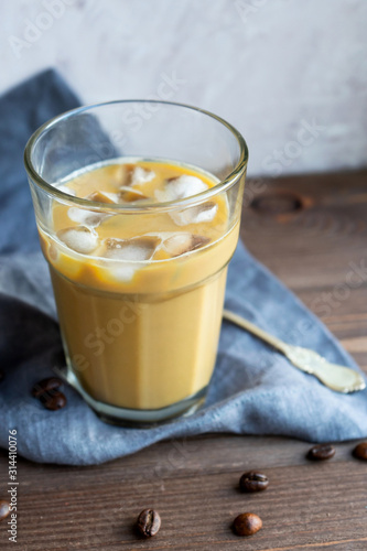 A glass of refreshing ice coffee with milk