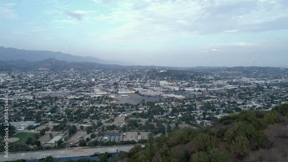 Aerial over hiking ridge in griffith park revealing Glendale and San Gabriel mountains Aerial over hiking ridge in griffith park revealing Glendale and San Gabriel mountains