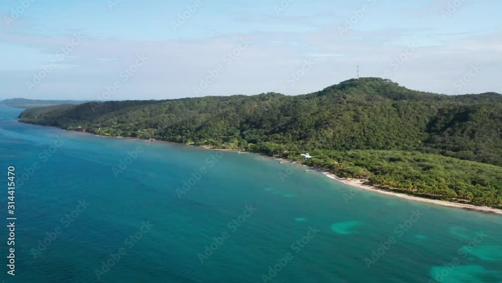 Cinematic aerial, slow high rotating reveal of tropical island coastline, East End Roatan Cinematic aerial, slow high rotating reveal of tropical island coastline, East End Roatan