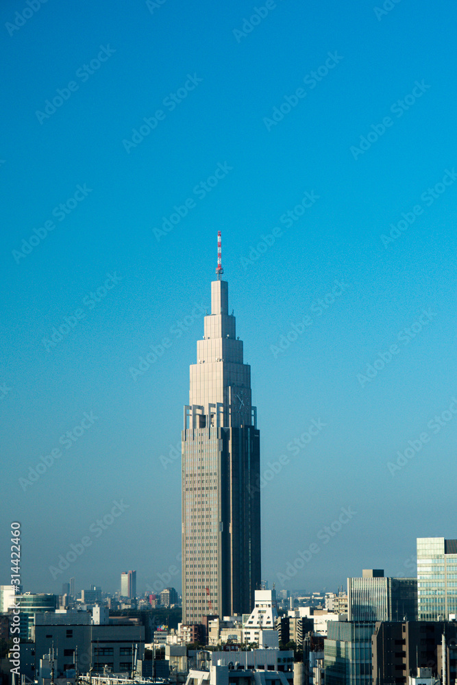 Obraz premium Japan / Tokyo - October 30 2019: NTT DOCOMO Yoyogi Building with sky in the morning. Japan city urbanscape real estate.
