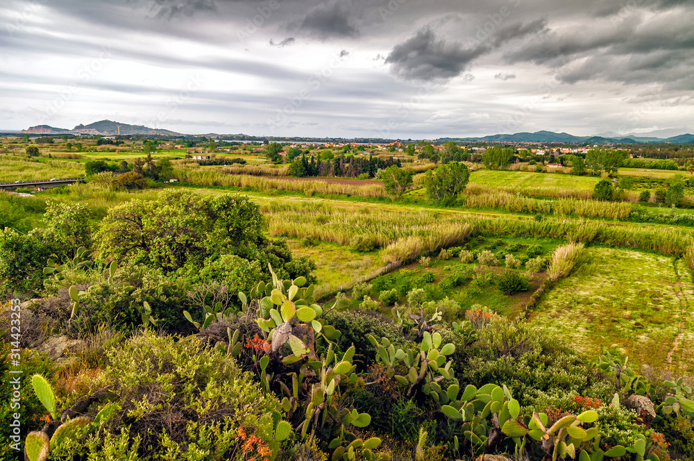 Extensive rural landscape with meadows, hedges and orchard (Ogliastra region, east Sardinia, Italy)) during stormy weather.