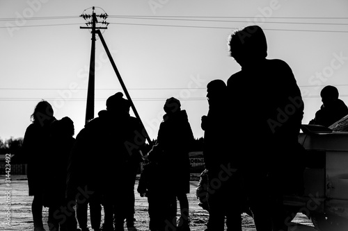 Schilderij op canvas silhouettes of people refugees in the street. black and white