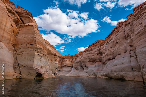 View of narrow, cliff-lined canyon from a boat in Glen Canyon National Recreation Area, Lake Powell, Arizona.