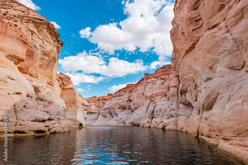 View of narrow, cliff-lined canyon from a boat in Glen Canyon National Recreation Area, Lake Powell, Arizona.