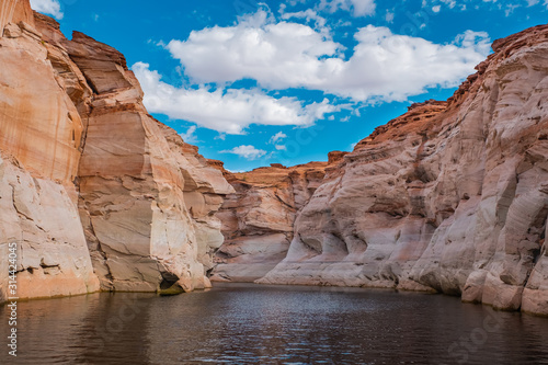 View of narrow, cliff-lined canyon from a boat in Glen Canyon National Recreation Area, Lake Powell, Arizona.