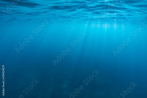 Underwater of tropical reef with sea sun rays passing through water.