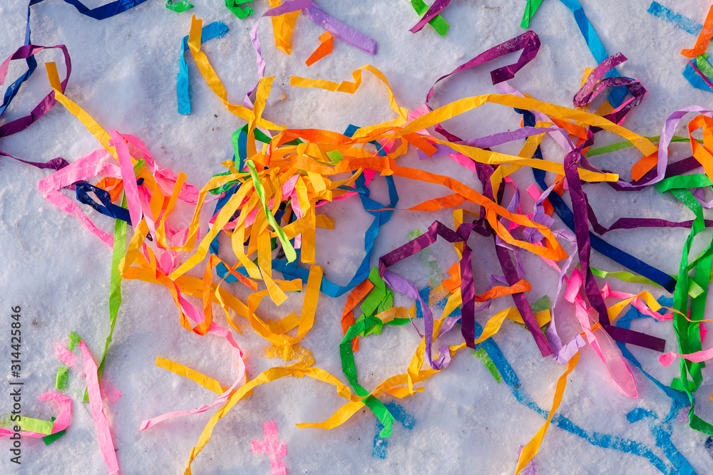 Bright colorful paper ribbons in the snow