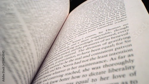 Quickly fanning through pages of a book in slow motion, filmed on RED 8K Camera 