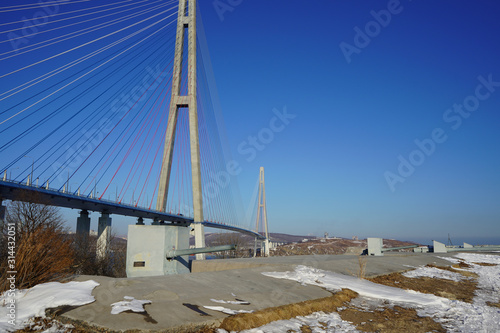 Landscape with a view of the Russian bridge against the blue sky. photo