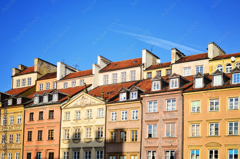 Old tenement house with facade buidling in sequence in Warsaw in old town. Windows in  complex building in Poland.