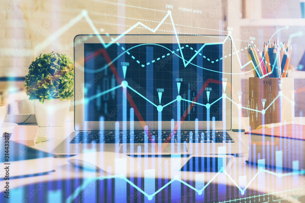 Financial market graph hologram and personal computer on background. Multi exposure. Concept of forex. Financial market graph hologram and personal computer on background. Multi exposure. Concept of forex.