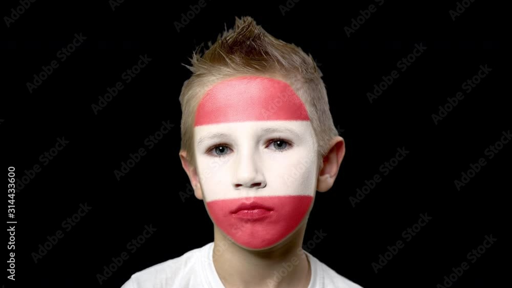 Sad fan of the football team of Austria. A child with a face painted in national colors. Unhappy boy with sad eyes. Fiasco of your favorite team. Disappointment. Sadness. Experience. Failure. Bad luck Sad fan of the football team of Austria. A child with a face painted in national colors. Unhappy boy with sad eyes. Fiasco of your favorite team. Disappointment. Sadness. Experience. Failure. Bad luck