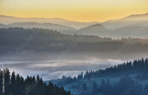 morning Carpathians. scenic sunrise in the mountains. autumn fog © sergnester