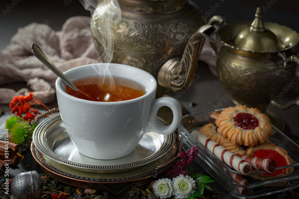 Fototapeta premium Tea hot drink on old background in composition on the table