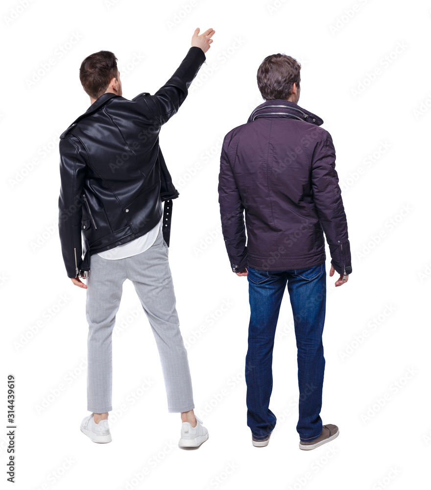 Back view of couple couple in winter jackets pointing. Back view of couple couple in winter jackets pointing.
