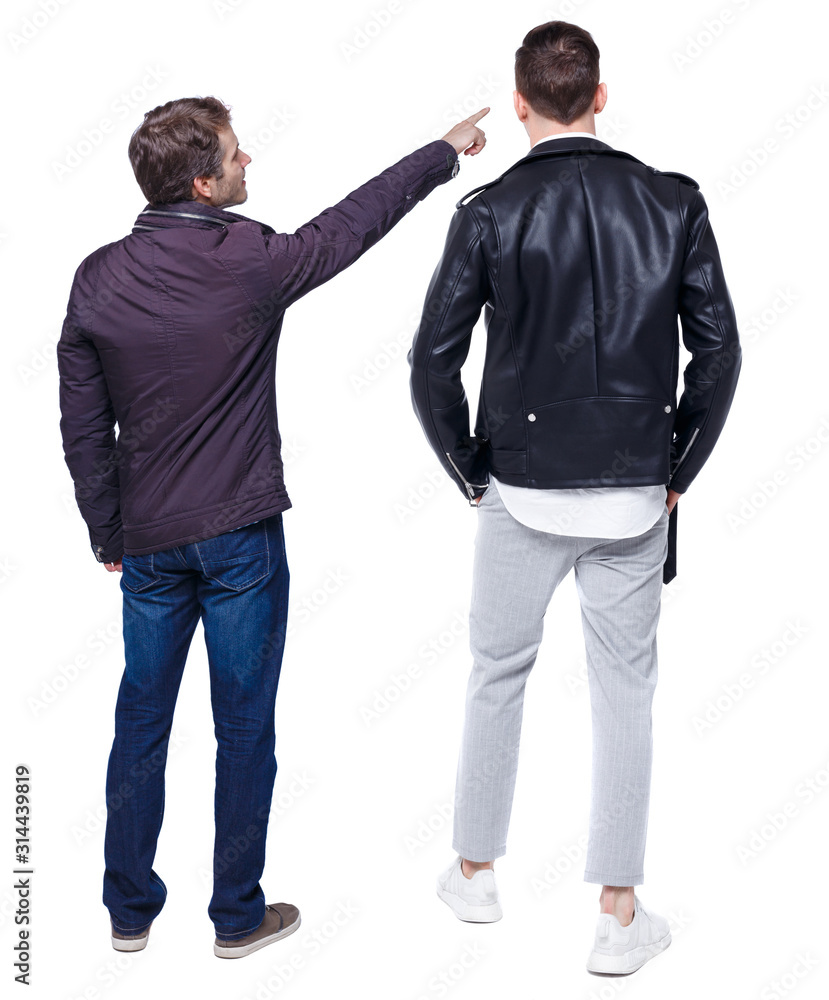 Back view of couple couple in winter jackets pointing. Back view of couple couple in winter jackets pointing.