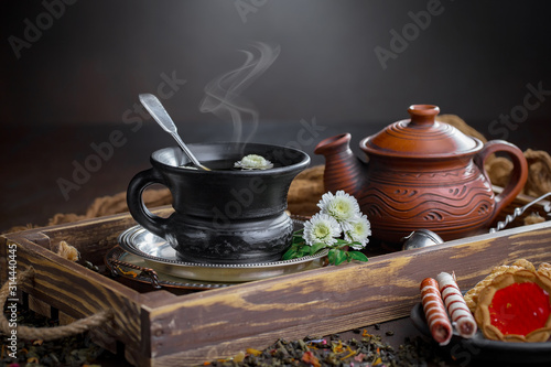 Tea hot drink on old background in composition on the table