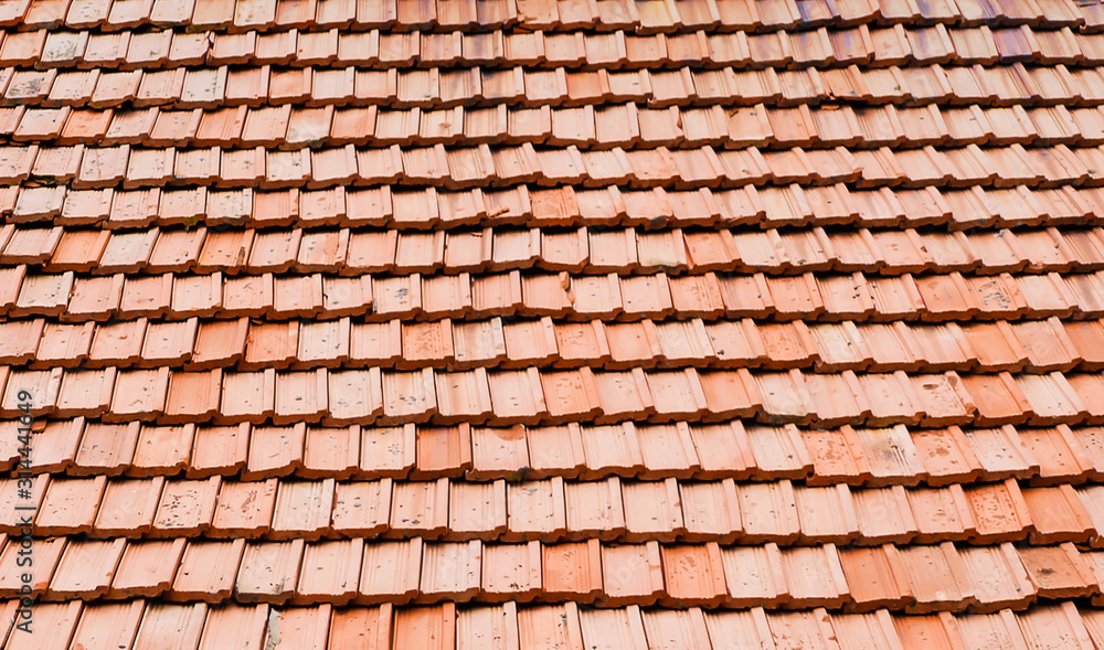 Texture of old red clay roof tiles on a building roof