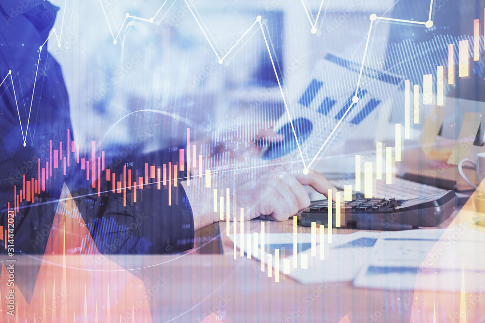 Double exposure of graph with man typing on computer in office on background. Concept of hard work. Closeup. Double exposure of graph with man typing on computer in office on background. Concept of hard work. Closeup.