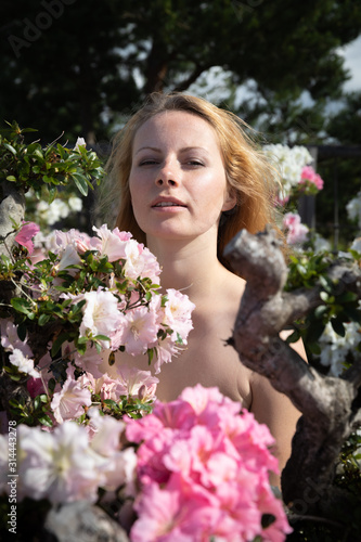young woman among the flowers of azalea © misu